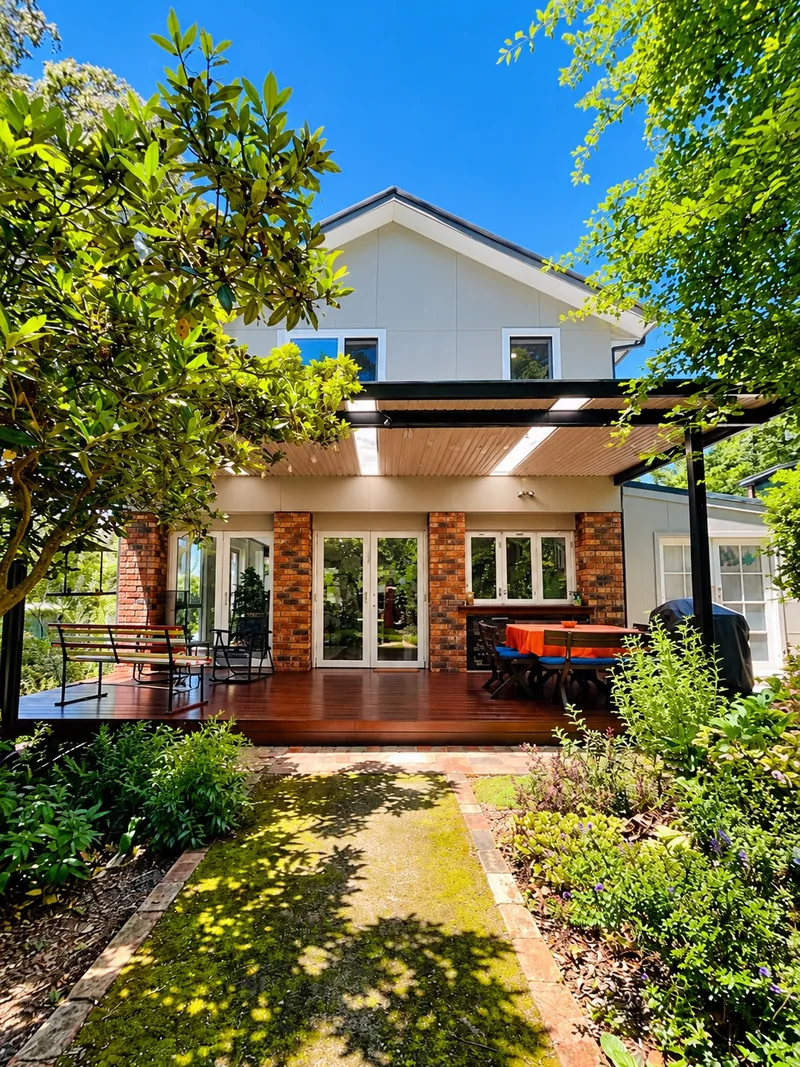 The two-storey cottage and its outdoor living spaces